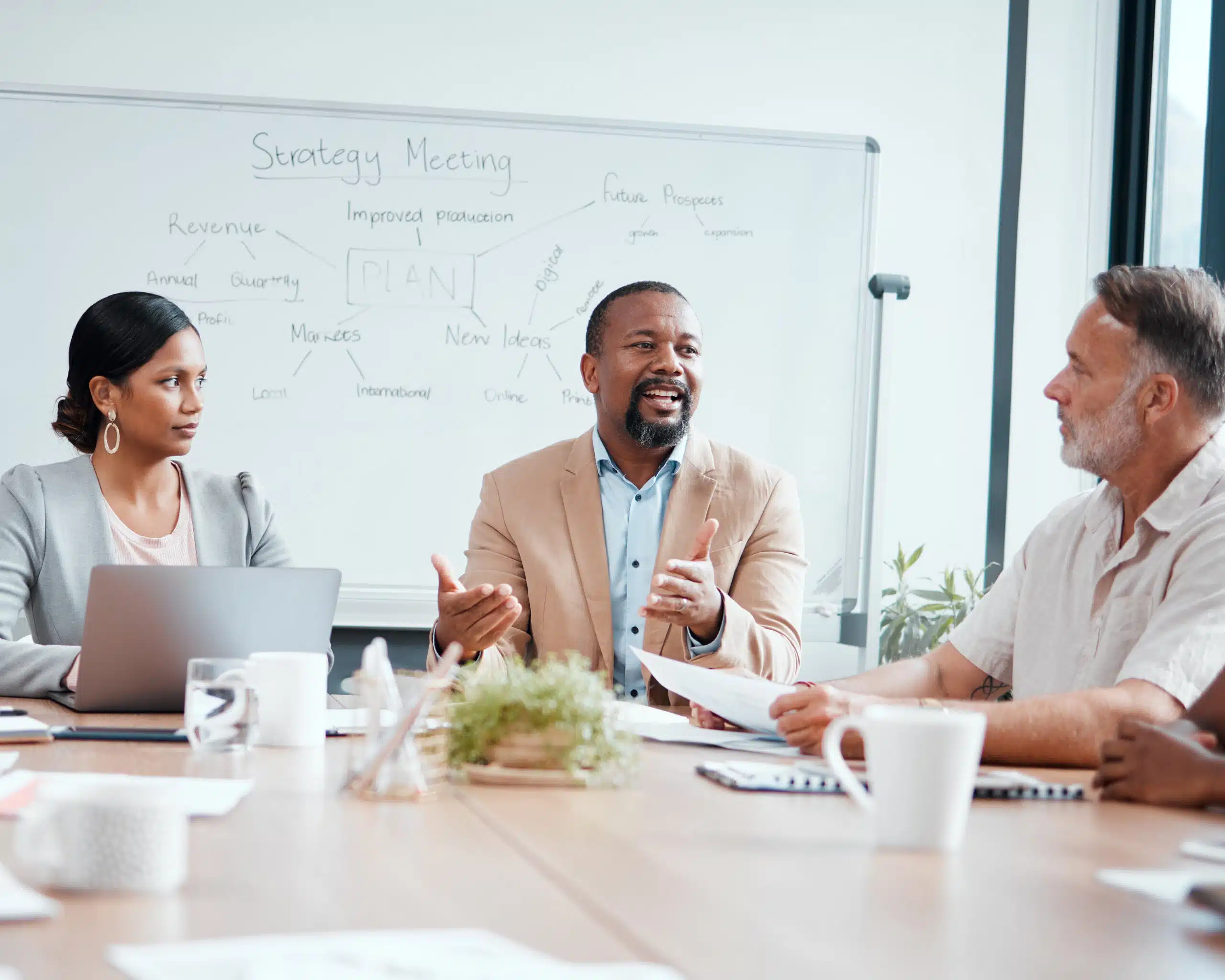 Business professionals discussing audit management with smiles around a meeting table