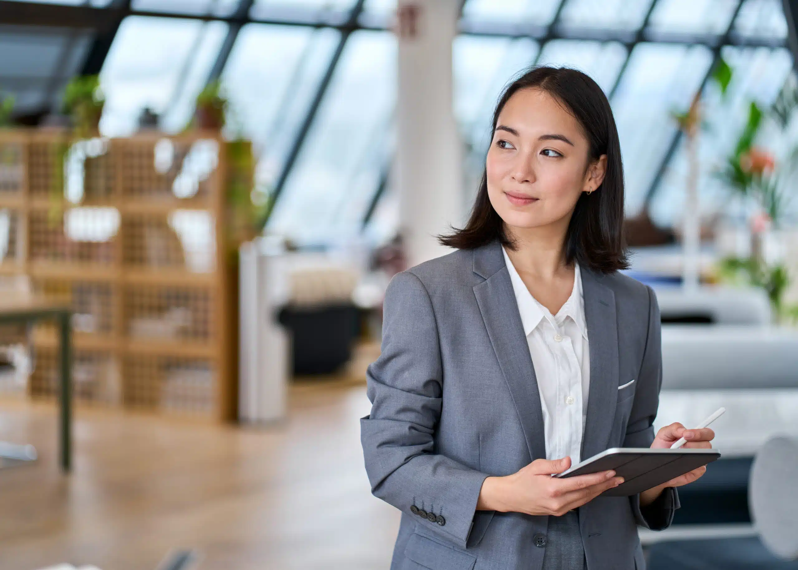 Business woman smiling while able to review a complaint on the go with her tablet