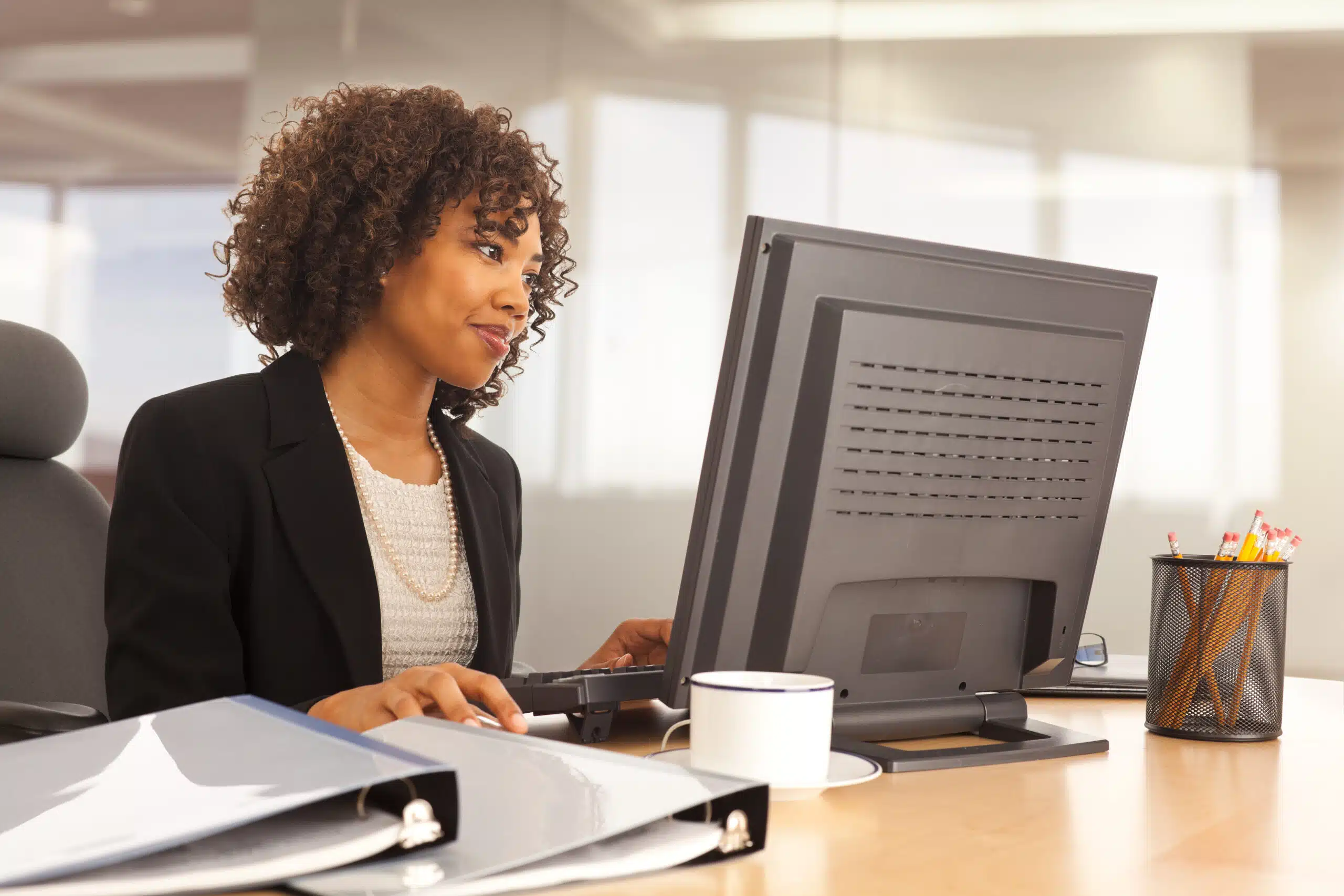 A woman at her desk digitally intaking a complaint