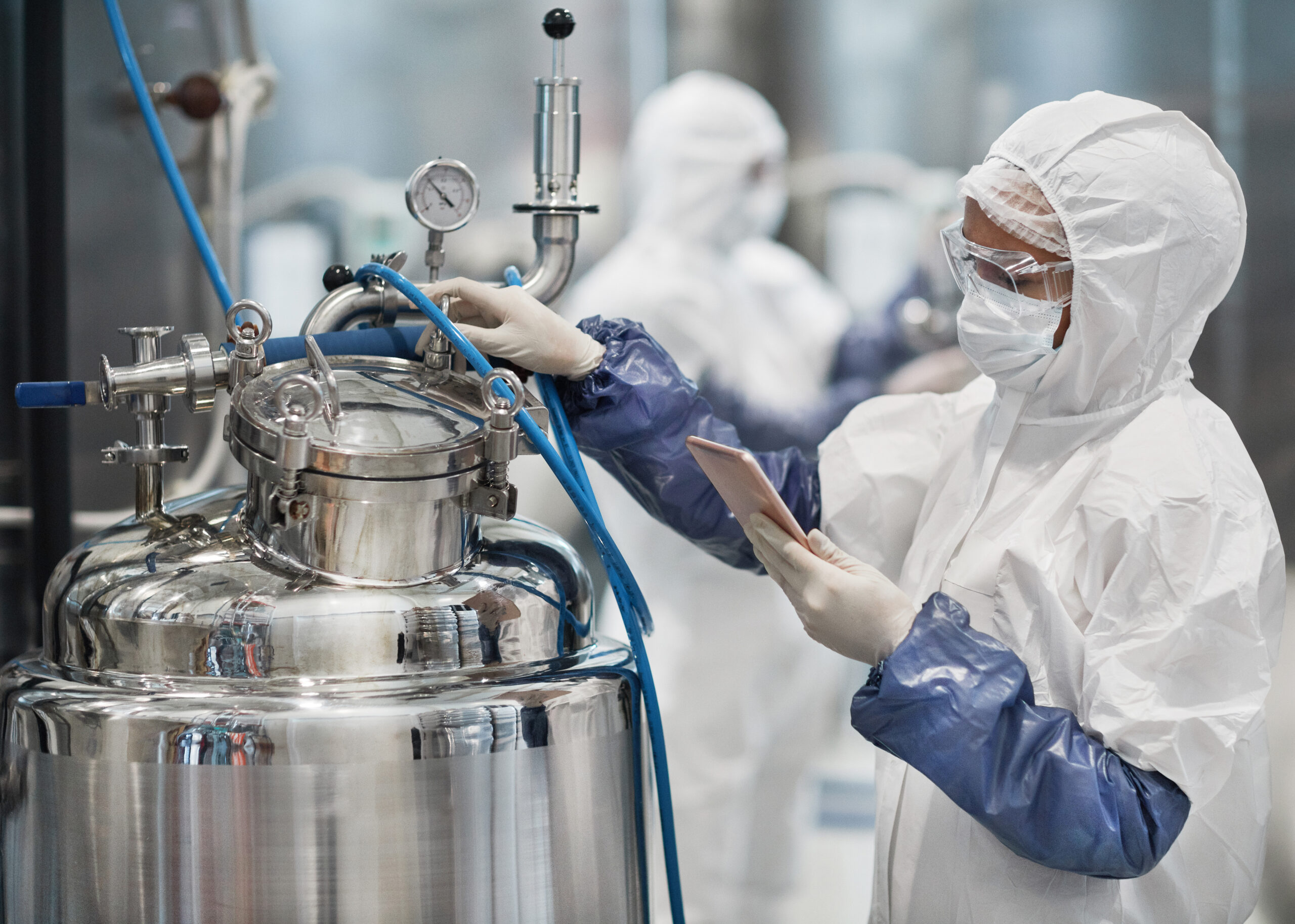 A worker efficiently logging a deviation while in a lab with a digital deviation software on a tablet