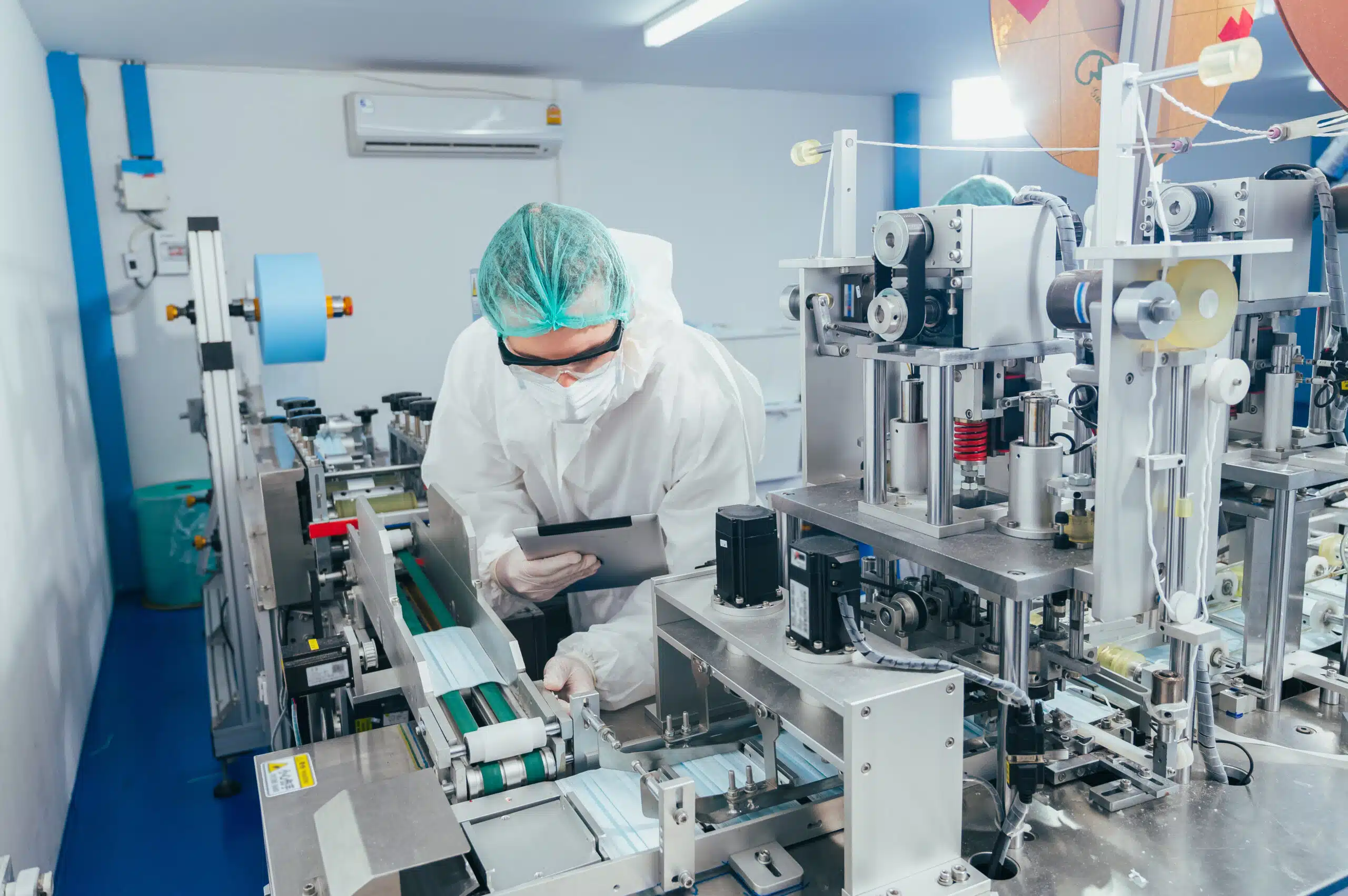 A man with a tablet digitally logging a nonconformance in a medical device production plant